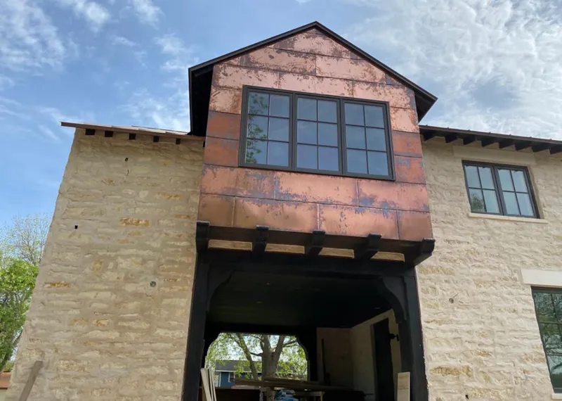 Copper metal panel facade on a stone building for Metal Roof Coating in Mill Creek