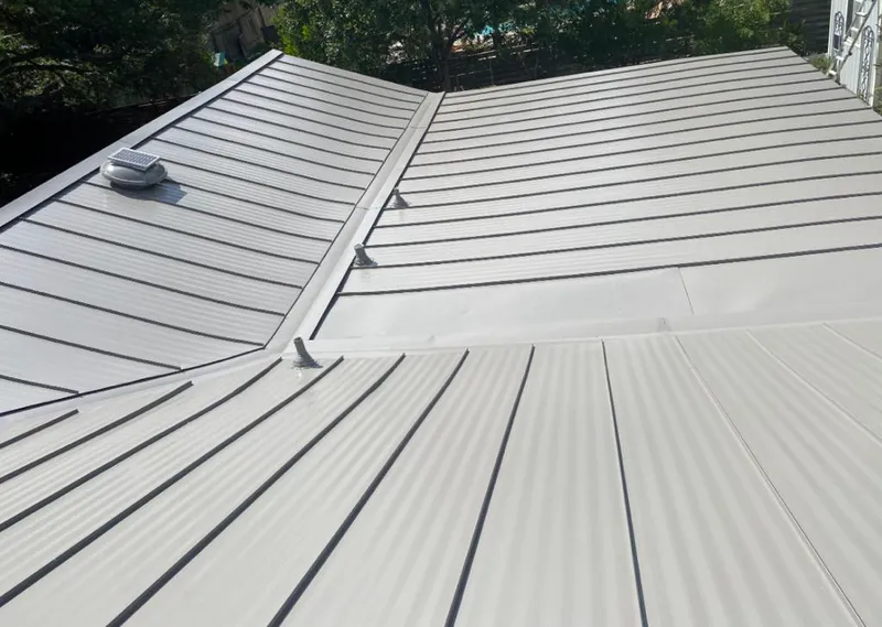 Solar attic fan installed on a metal roof for Roof Ventilation in Mill Creek
